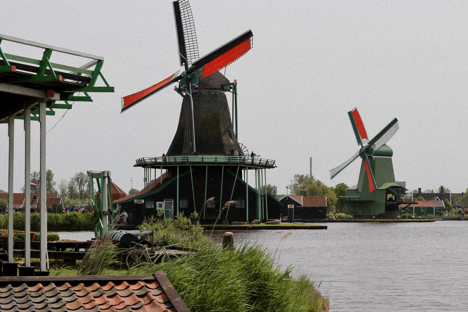 Picturesque view of historic windmills at Zaanse Schans, showcasing Dutch heritage.